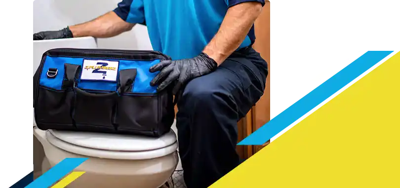 Z PLUMBERZ of North America technician kneeling with tool bag on toilet