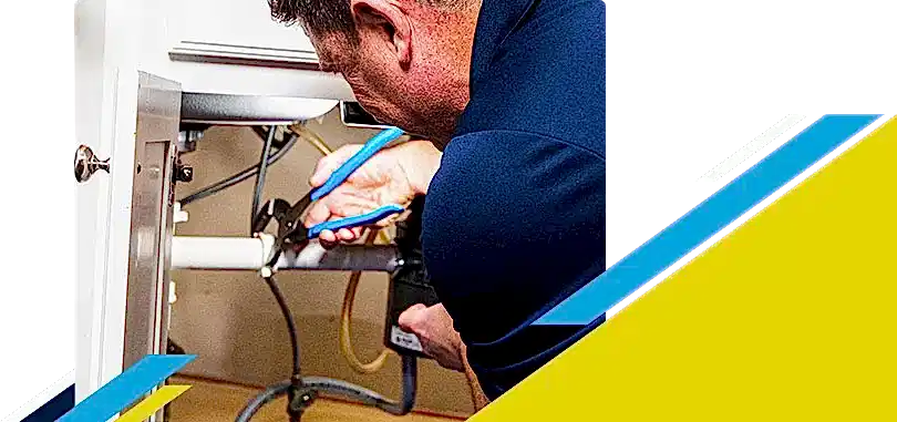 Z PLUMBERZ of Greater Boston technician fixing pipe under a sink