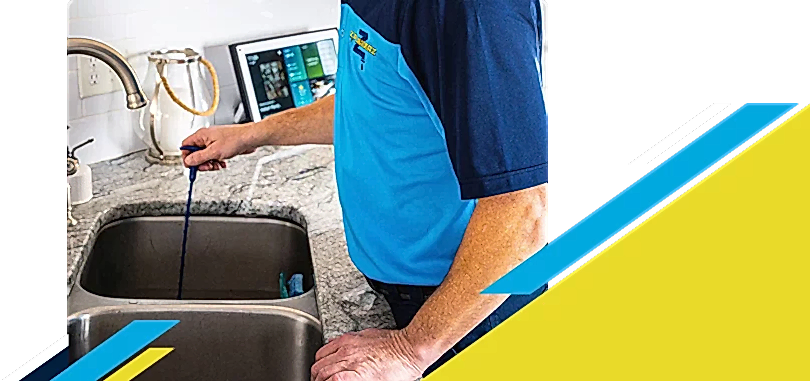 Z PLUMBERZ of Greater Boston technician unclogging drain 