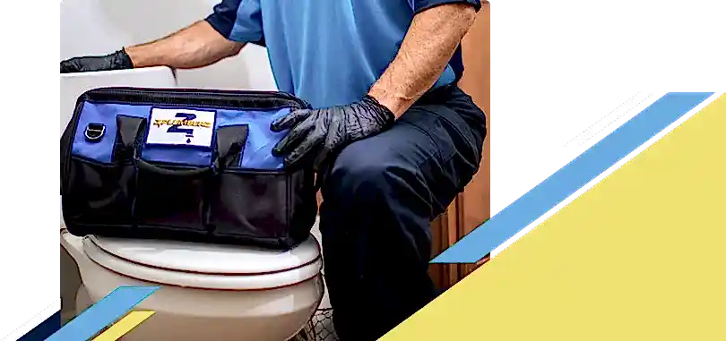 Z PLUMBERZ of Greater Boston technician kneeling with tool bag on toilet