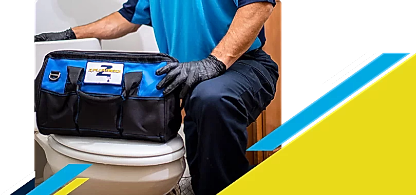 Z PLUMBERZ of Riverside technician kneeling with tool bag on toilet