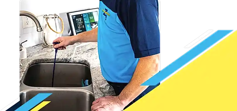 Z PLUMBERZ of Bergen technician unclogging drain 