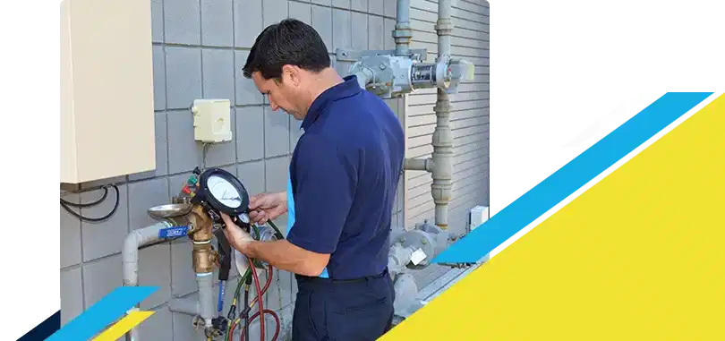 Z PLUMBERZ of Jupiter technician using a tool to measure backflow