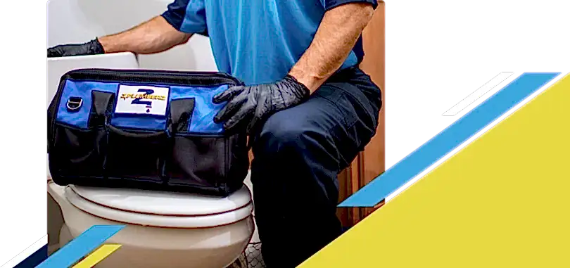 Z PLUMBERZ of East Valley technician kneeling with tool bag on toilet