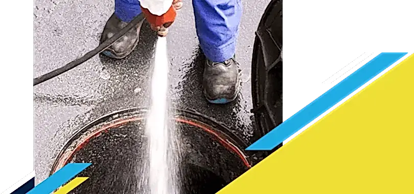 Z PLUMBERZ of Atlanta technician spraying water down a manhole