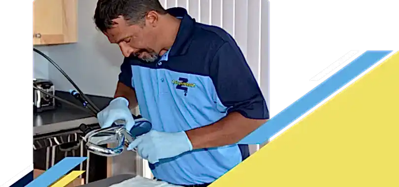 Z PLUMBERZ of Atlanta technician inspecting sink faucet assembly